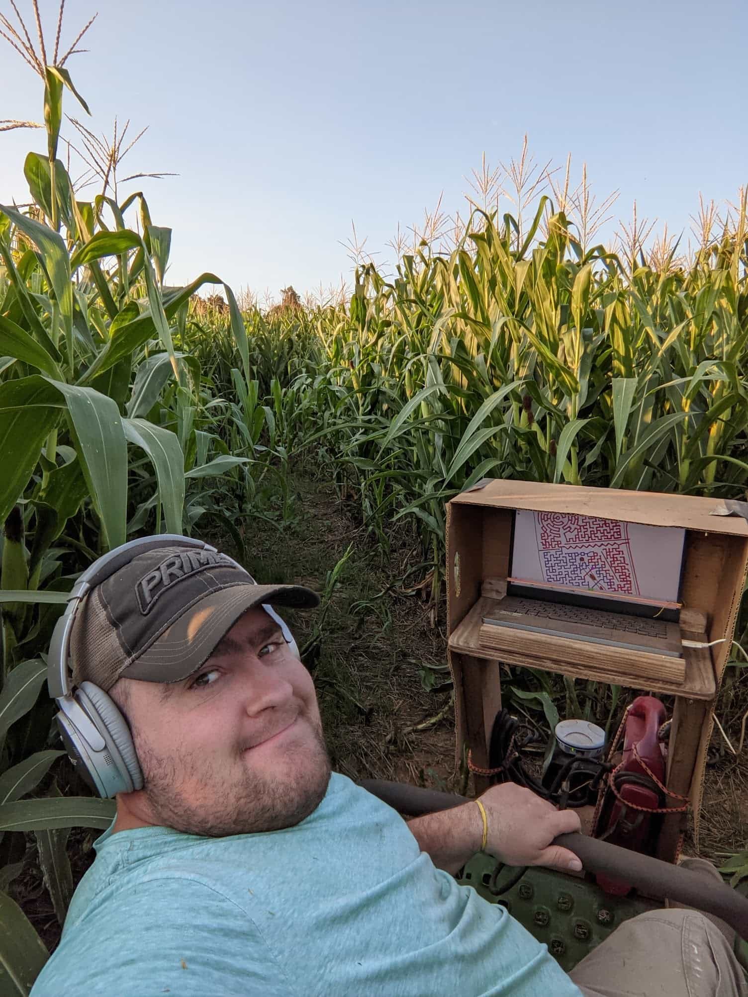 Eldon Yoder using GPS equipment while cutting a corn maze